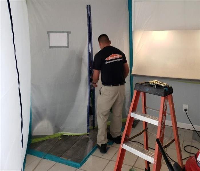 Man standing in front of plastic containment